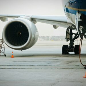 A plane's engine and landing gear are visible.