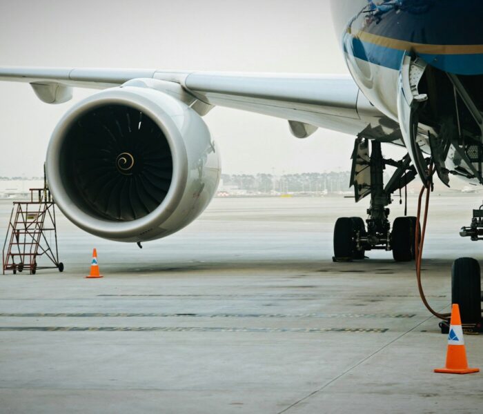 A plane's engine and landing gear are visible.