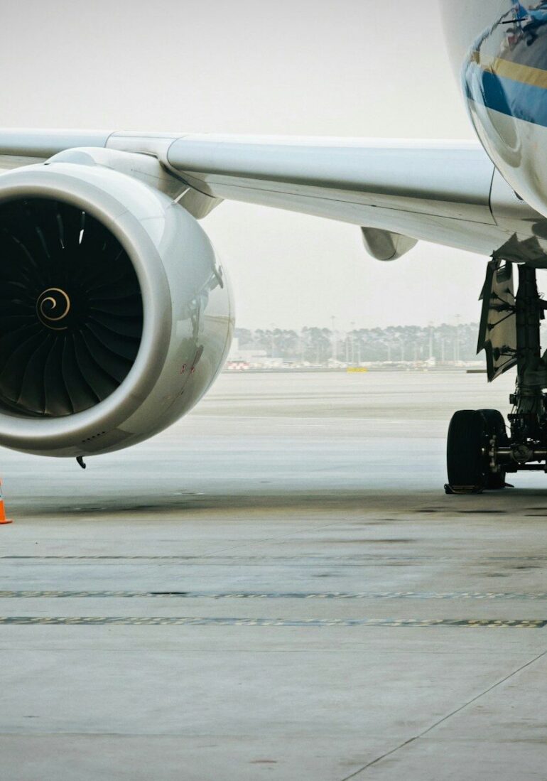 A plane's engine and landing gear are visible.