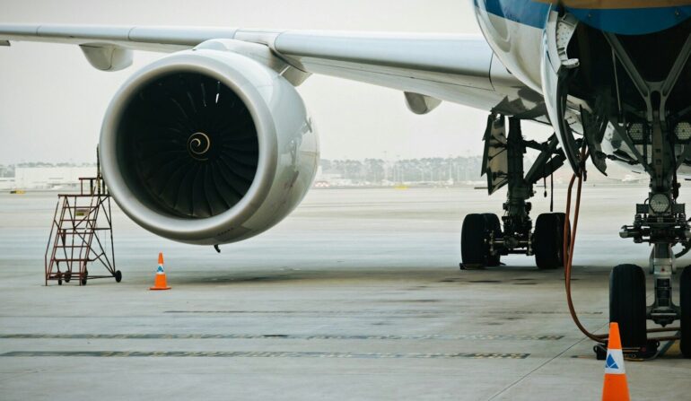 A plane's engine and landing gear are visible.