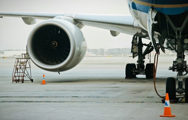 A plane's engine and landing gear are visible.