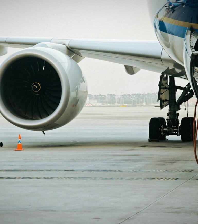 A plane's engine and landing gear are visible.