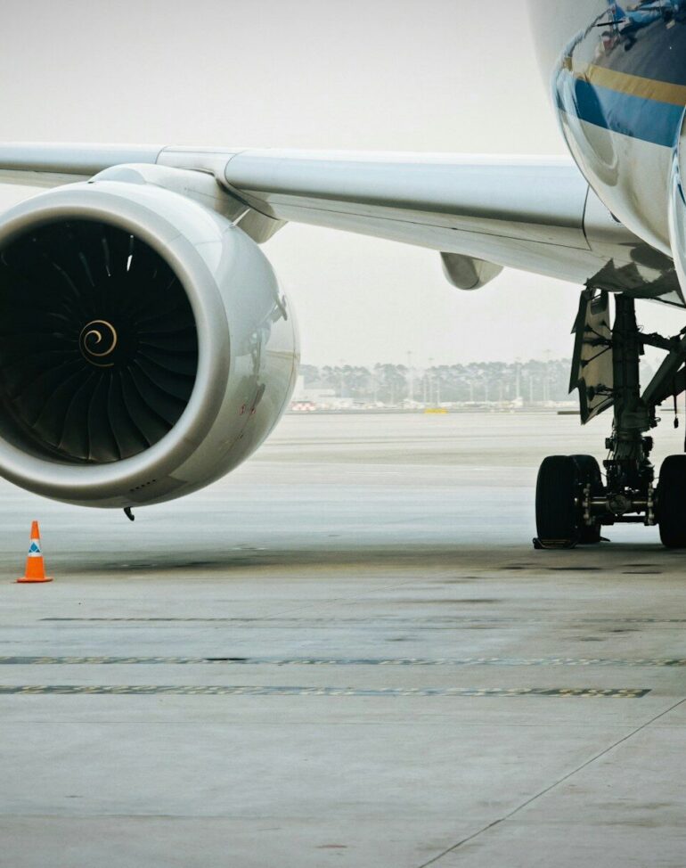 A plane's engine and landing gear are visible.