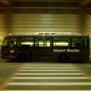 red and black bus on gray road