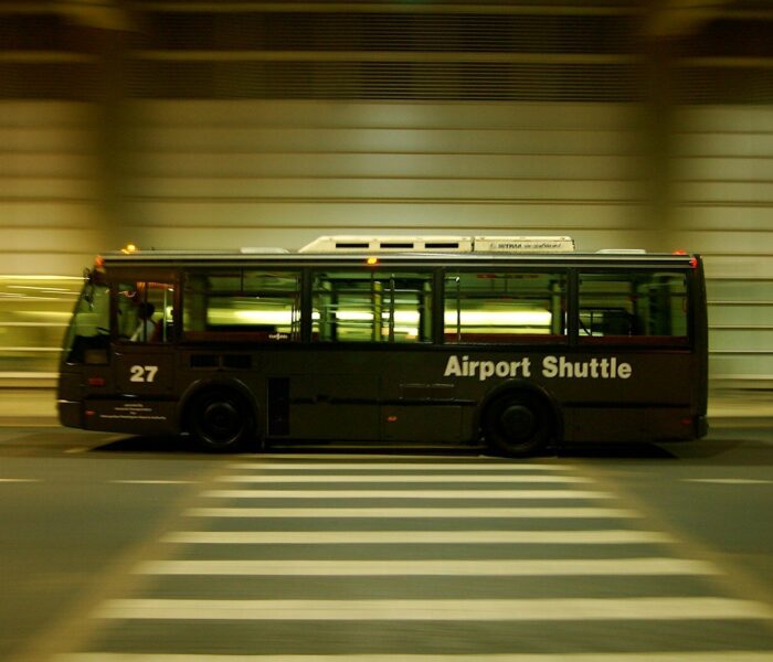 red and black bus on gray road