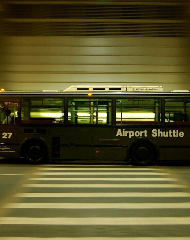 red and black bus on gray road