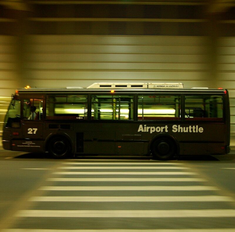 red and black bus on gray road