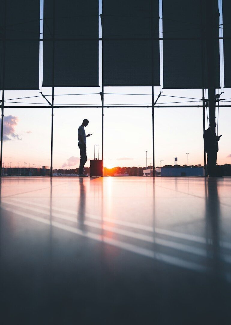 silhouette of person across gray clouds