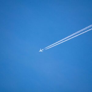 An airplane is flying high in the sky