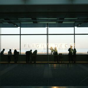 A group of people standing in front of a window