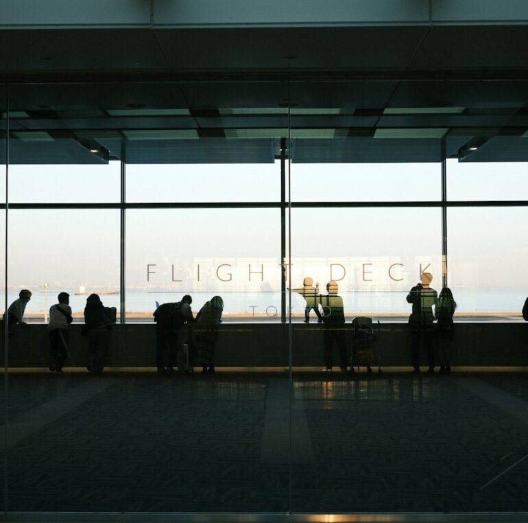 A group of people standing in front of a window