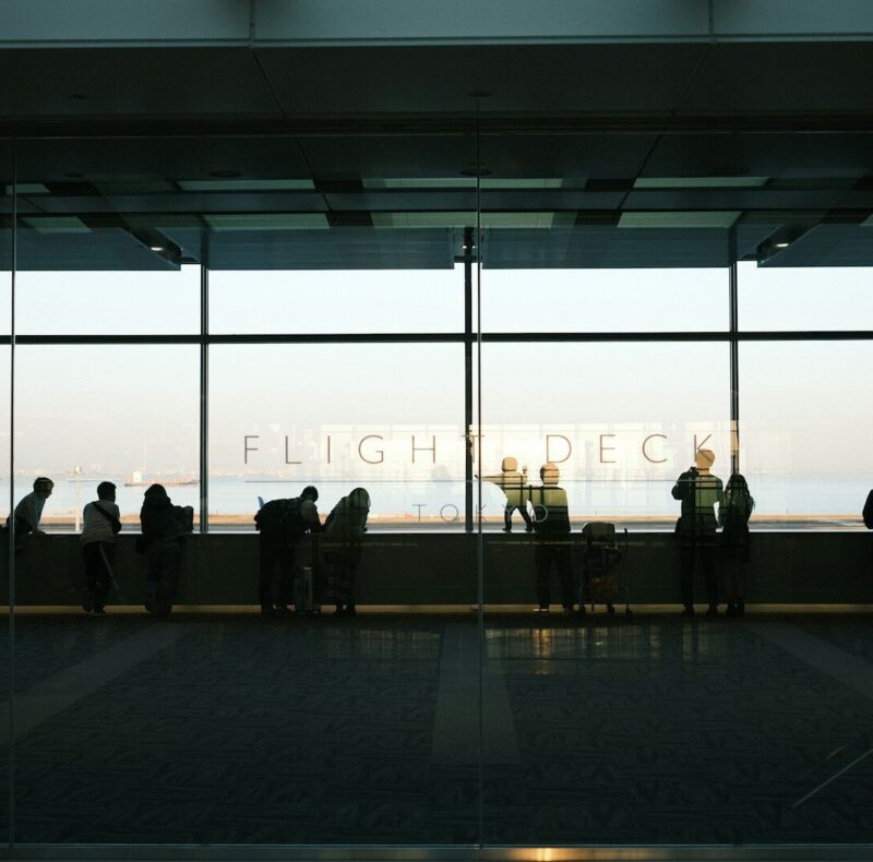 A group of people standing in front of a window