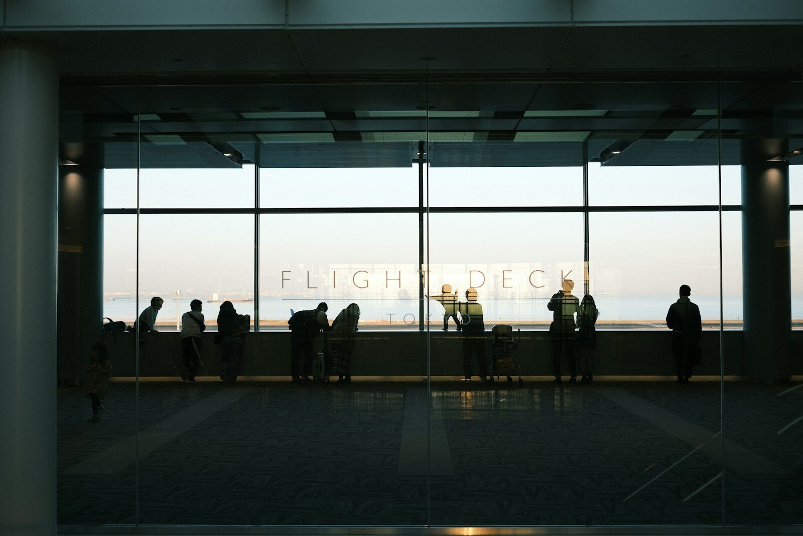A group of people standing in front of a window