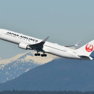 A large jetliner flying through a blue sky