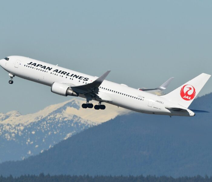 A large jetliner flying through a blue sky